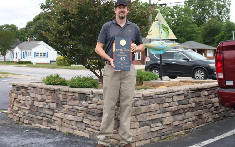 Sunshot by Grayson Williams — Mark Seabolt poses for a photo similar to one his father Fletcher Seabolt, had taken once. Mark took over the Hartwell Dairy Queen that his father opened after Fletcher died in a car crash in 2018.