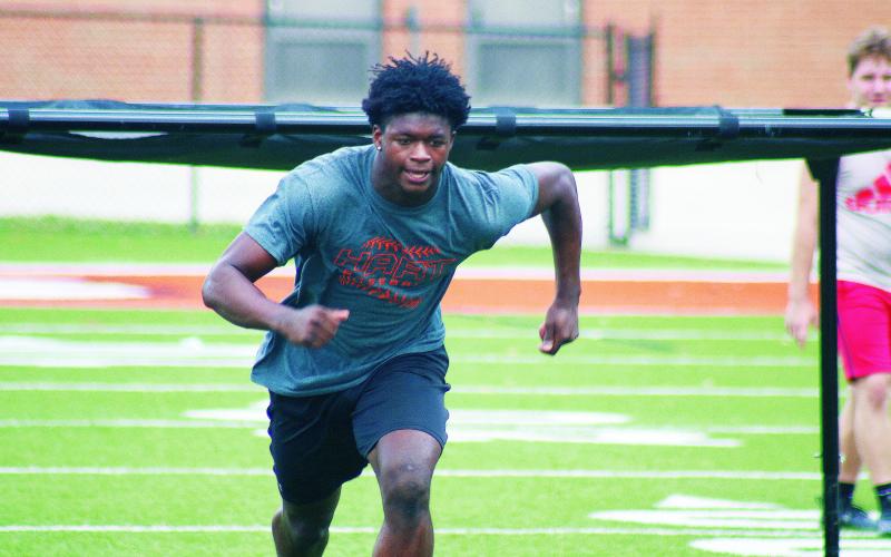 Senior running back Malachi Thomas darts out of the shoot during a drill on Monday.