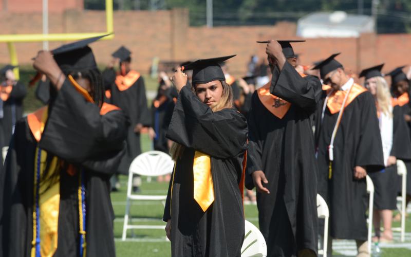 Miyann Vaca, center, turns the tassel on her cap to end the 2020 graduation ceremony at Hart County High School on Saturday.