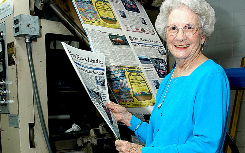 Sunshot from file by Bill Powell — Wassie Vickery holds a newspaper fresh off the press at The Hartwell Sun in 2006.