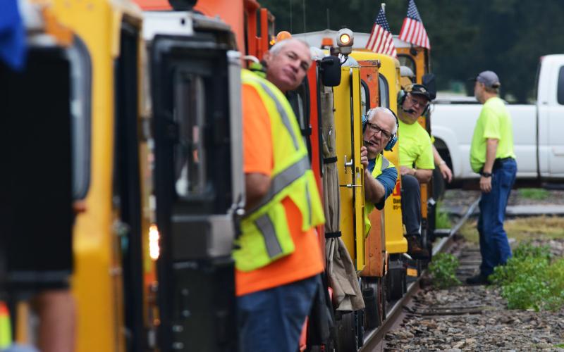 Phil Strine, of Canton, middle, peers out from the operator’s seat anticipating the start of the excursion.