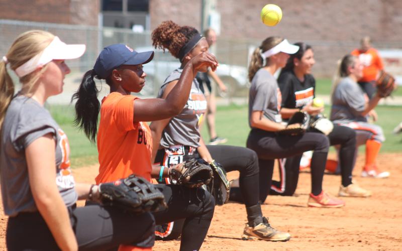 Sunshot by Grayson Williams — Hart County Lady Bulldog softball players throw from one knee during practice Tuesday, Aug. 4, at Hart County High School.
