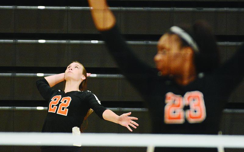 Sunshot by Michael Hall - Madison Wolfe serves during the Hart County Volleyball team’s win over Rabun County on Aug. 20 as LaMaya Sessoms prepares for action.