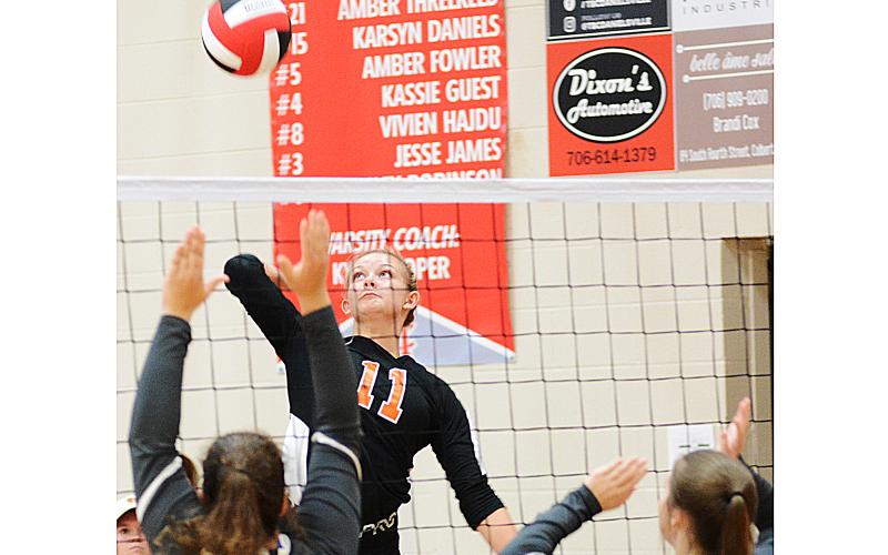 Sunshot by Michael Hall — Alex Burdette spikes the ball against Madison County at the Madison County Round Robin Tournament at Madison County High School on Saturday, Aug. 15.