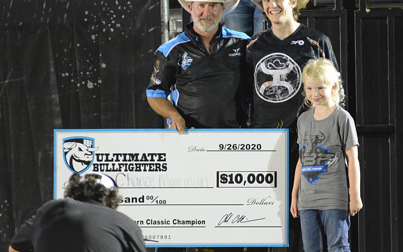 Chance Moorman, of Lytle, Texas, center, accepts a check for $10,000 from Chad Ellison for winning the UBF Southern Classic in Bowersvile on Saturday, Sept. 26.
