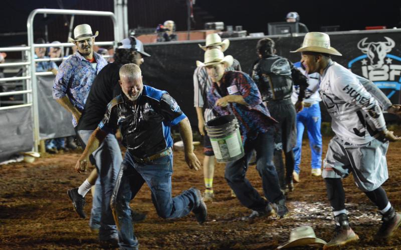 Bullfighters throw water on Chad Ellison, of Chad Ellison Fighting Bulls and Franklin County Livestock after the competition to celebrate Ellison’s birthday.
