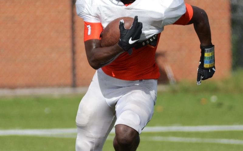 Sunshot by Michael Hall - Malachi Thomas runs with the football during the scrimmage on Aug. 29 at Herndon Stadium.