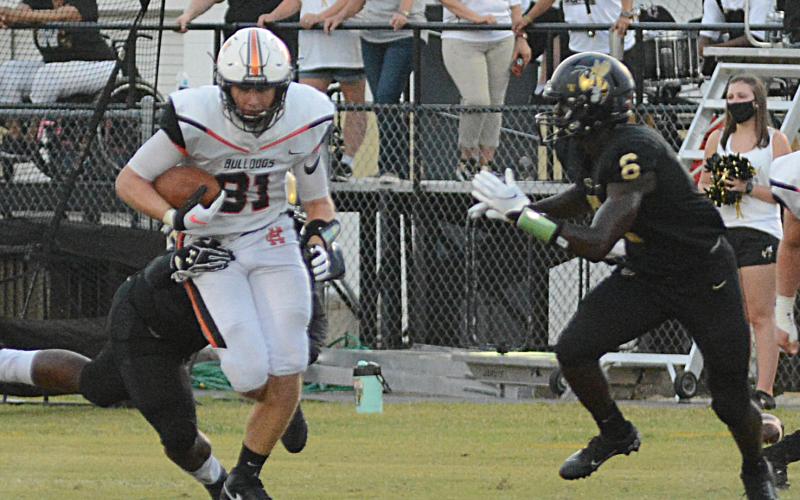 Sunshot by LaDonna Harris - Hart County’s Cane Berrong tries to shed a tackler Friday, Sept. 4, against Wayne County in Jesup.
