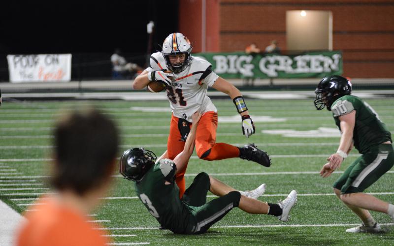 Sunshot by Grayson Williams Hart County’s Cane Berrong knocks over a North Hall defender on his way to a big gain on Sept. 18 in Gainesville.