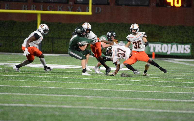 Hart County’s Jaricus “Scooter” Harper, above, grabs the shirt of a North Hall ball carrier on Sept. 18 in Gainesville