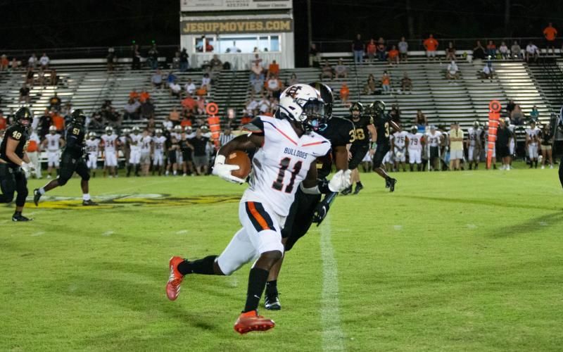 Photo submited by Davontay Wilson - Hart County’s Paul Davis tries to get around the edge after a catch on Friday, Sept. 4, against Wayne County in Jesup. The Bulldogs fell in their opener to the Yellow Jackets, 29-13.