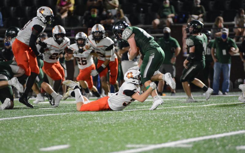 Levi Lystiuk, above, pulls down a North Hall runner in Gainesville on Sept. 18.
