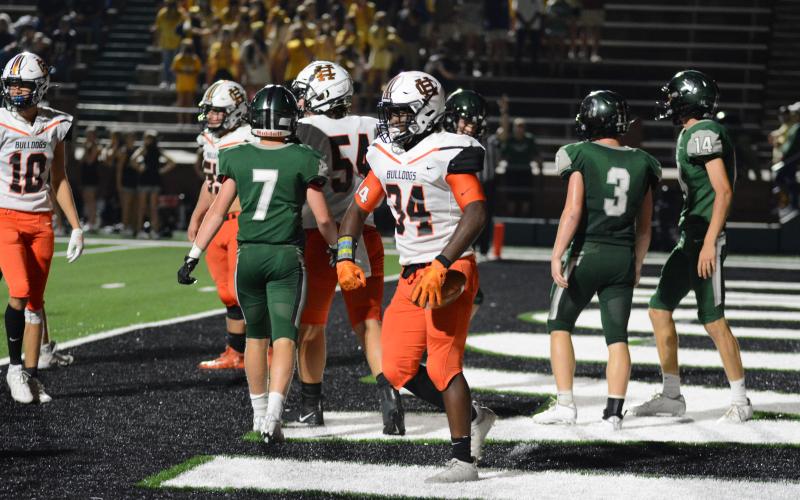 J.L. Lackey, below, flexes after scoring a touchdown.