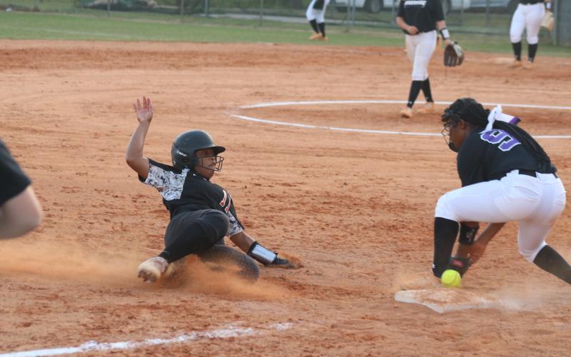 Sunshot by Grayson Williams Zoe Brock slides into third base safely on Tuesday at Hart County High School in the Lady Diamond Dogs’ senior night win over Monroe Area.