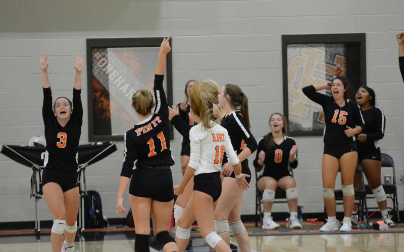 Sunshot by Grayson Williams - The Hart County Volleydogs celebrate on Tuesday, Sept. 15, at Hart County High School after a point in matches that ended with the team undefeated in Region 8-AAA and in first place.