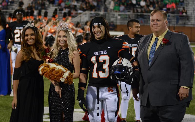 The newly crowned Miss Bulldog, Trinity Chastain, second from left, poses for pictures with last year’s Miss Bulldog, Anna Rucker, left, Chastain’s escort Ty Shiflet, second from right, and Hart County High School principal Kevin Gaines.