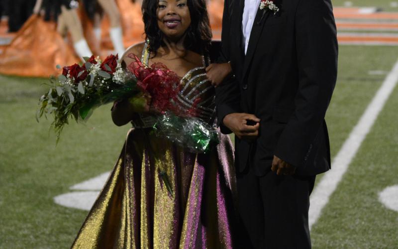 Taylor Freeman, left, smiles with her father and escort, Tyler Freeman, after being crowned the 2020 Homecoming Queen for Hart County High School on Friday, Oct. 16, at Herndon Stadium.