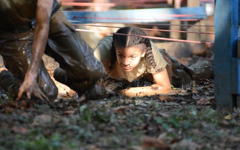 Kiara Mayfield emerges from mud in the low crawl obstacle.
