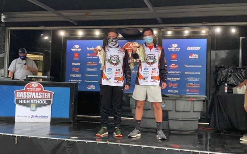 Dawson Carden, right, and Griffin Milford, left, show off fish they caught at the national championship on Kentucky Lake last week.