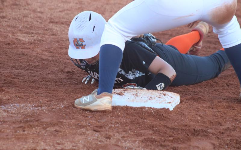Madison Bryson gets back to first base to avoid a pickoff play on Monday in the Lady Diamond Dogs’ win over East Jackson.