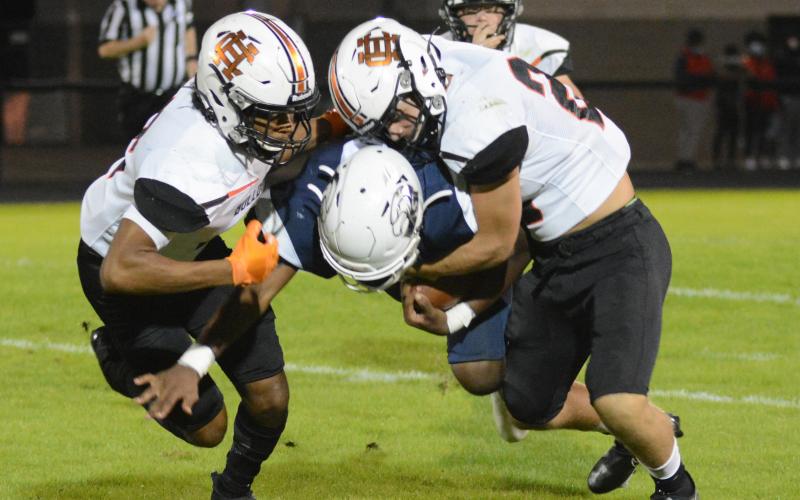 Hart County’s Montae Maxwell, left and Aiden Myers, right, bring down an East Jackson ball carrier on Nov. 13 in Commerce.