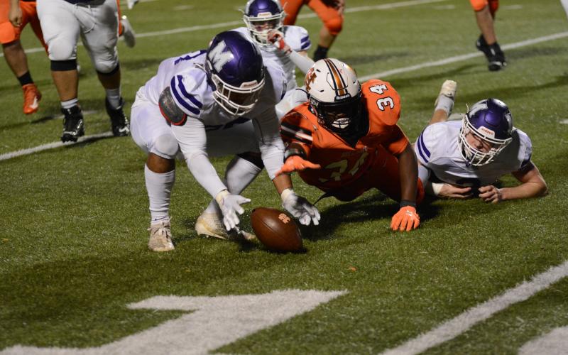 Hart County’s J.L. Lackey reaches for a ball on the ground after a fumble in the Bulldogs’ 19-16 loss at home to Monroe Area on Nov. 20.