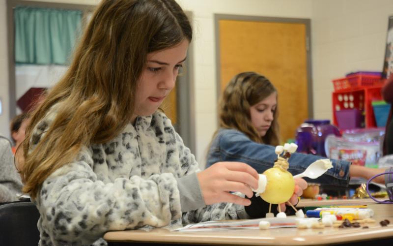 Fourth-grader Trinity Floyd puts the finishing touches on her apple turkey, a craft project classes completed to celebrate the Thanksgiving holiday.