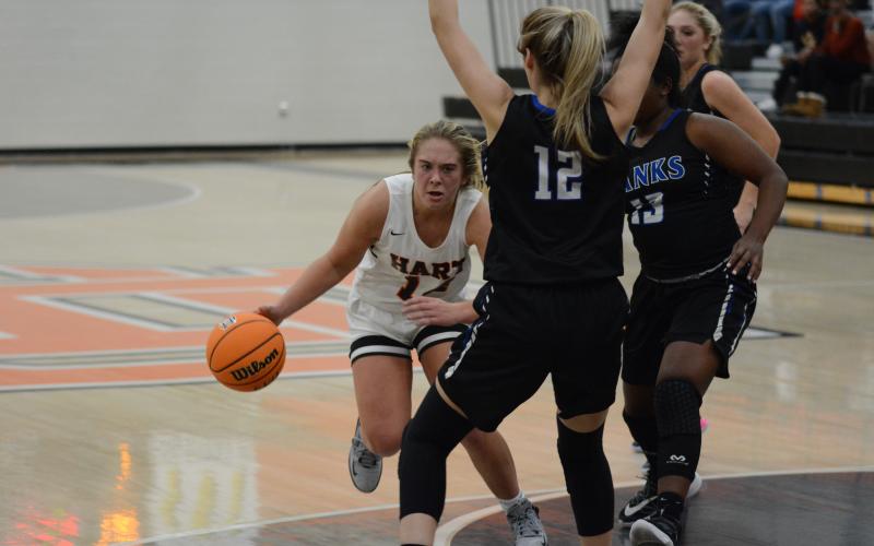 Sunshot by Grayson Williams Hart County’s Dakota Phillips dribbles around Banks County defenders in a scrimmage at Hart County High School on Nov. 17.
