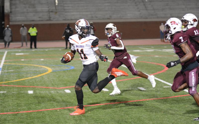 Sunshots by Grayson Williams Hart County’s Paul Davis flashes the peace sign towards defenders as he heads to the end zone in the Bulldogs 32-21 playoff loss to Carver (Atlanta) High School on Friday, Nov. 27 at Lakewood Stadium.