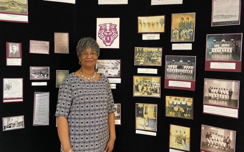 Loretta King poses for a photo in February with the African-American history exhibit she put together at The Art Center.