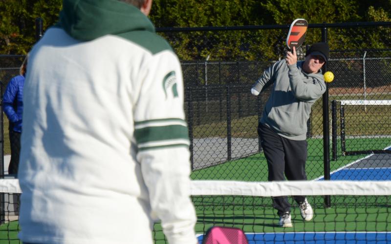 Sunshot by Michael Hall Eddie McCurley, right, hits the first serve ever on the new outdoor pickleball courts at the Bell Family YMCA to Frank Gunder on Tuesday, Dec. 1.