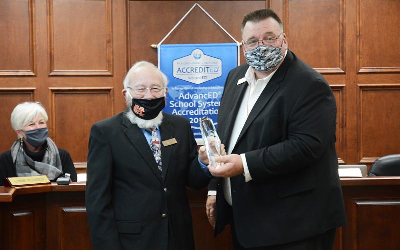 Sunshot by Michael Hall - Hart County Charter System superintendent, Jay Floyd, right, presents the Exemplary School Board award to board chairman Richard Sutherland.