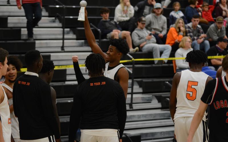Sunshot by Grayson Williams - Hart County’s Tahj Johnson holds up the McDonald’s Shootout championship trophy at Hart County High School on Dec. 30.