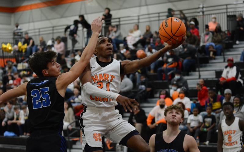 Sunshot by Grayson Williams - Shone “Spudd” Webb puts up a layup around Oconee County players on Friday, Jan. 22, at Hart County High School in the Bulldogs’ region victory over the Warriors.