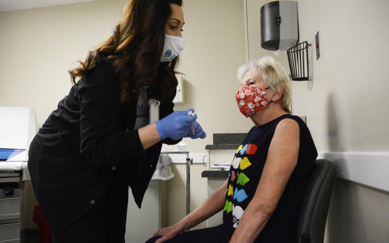 Sunshot by Michael Hall - MedLink nurse Trish Jones prepares to give a COVID-19 vaccine to Hartwell resident Lou Ann Farrar at MedLink in Hartwell on Friday, Jan. 15. The community health clinic vaccinated 100 people in a special vaccination event Friday.