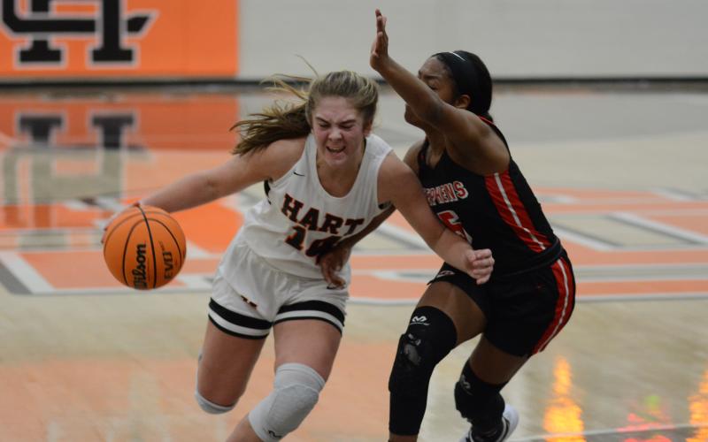 Sunshot by Grayson Williams - Dakota Phillips drives past a Stephens County defender on Tuesday, Jan. 19, at Hart County High School.