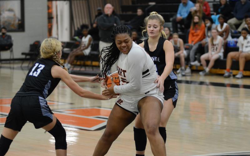 Sunshot by Grayson Williams - Taniya “Nesha” Alexander fights with Oconee County defenders for the ball on Monday at Hart County High.