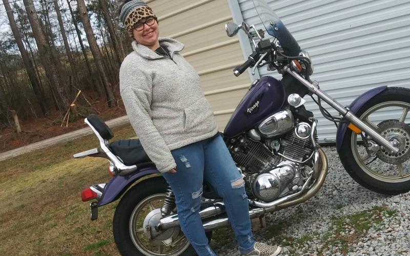 Brooke Dutton, event organizer for Women Ride, Women Build, poses with her bike.