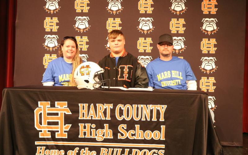 Sunshot by Grayson Williams Gabriel Coker, center, flanked by his mom, Amanda Morgan, and dad, Lee Morgan, signed last week to play college football at Mars Hill University.
