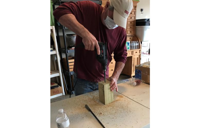 Don Meyer, above, makes a carpenter bee trap for Golden K recently.