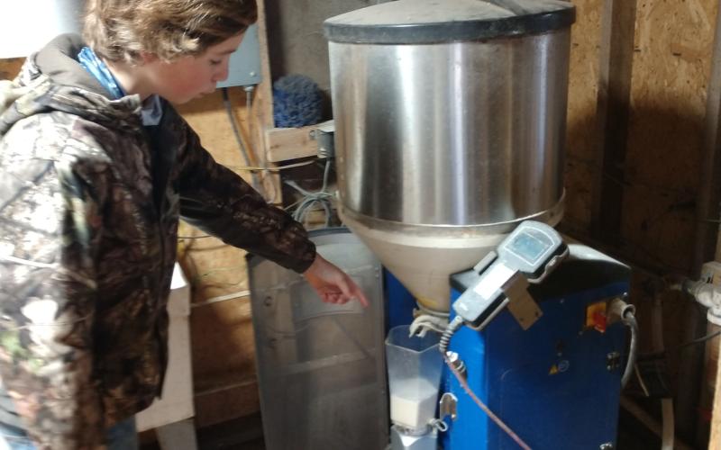 Max Martin helps monitor the replacement milk mixer for all the new heifer calves. The mixer monitors milk consumption for each calf daily.