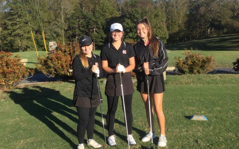 Mary Elizabeth Jackson, middle, stands with high school teammates Lauren Weaver, left, and Ella Franklin, right.