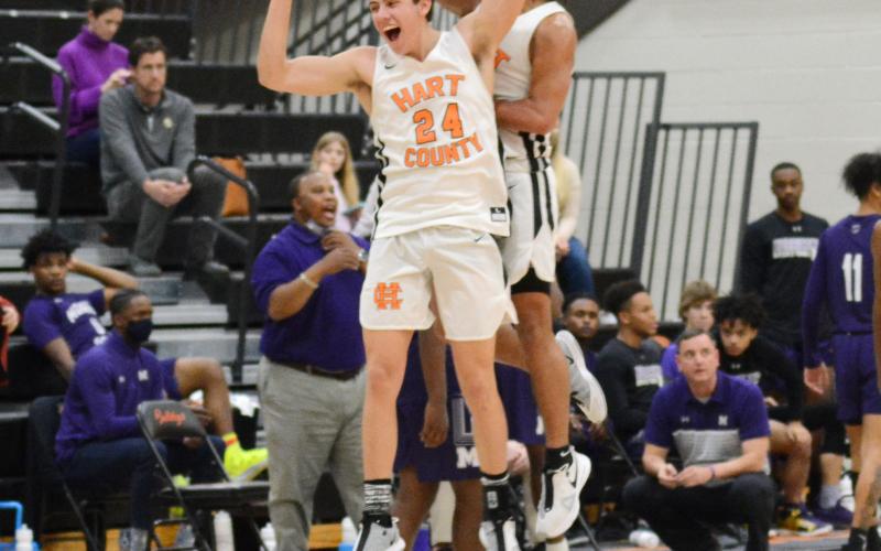 Ethan Spagnoli and Sean Teasley celebrate the Bulldogs’ Region 8-AAA victory on Saturday, Feb. 20, at Hart County High School.
