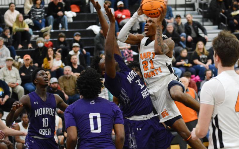 Shone “Spudd” Webb puts up a contested shot in the lane against a Monroe Area defender on Saturday, Feb. 20, at Hart County High School.
