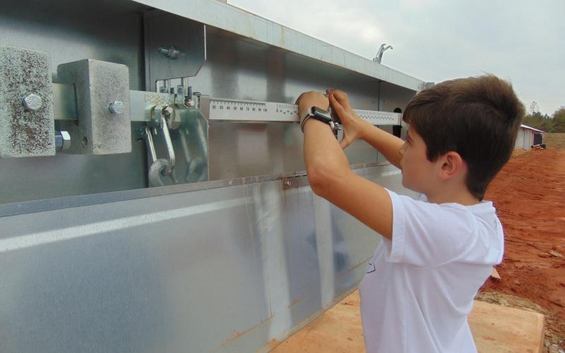 Middle schooler Seryn Singleton checks the scales at a poultry house in Hart County recently as part of the hands-on learning experience offered through FFA.