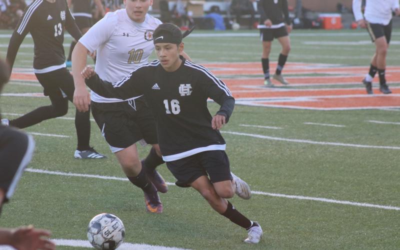 Sunshot by Grayson Williams Luis Genchi finds room between Commerce defenders in Hart County’s opening win on Monday, Feb. 8, at Hart County High School.