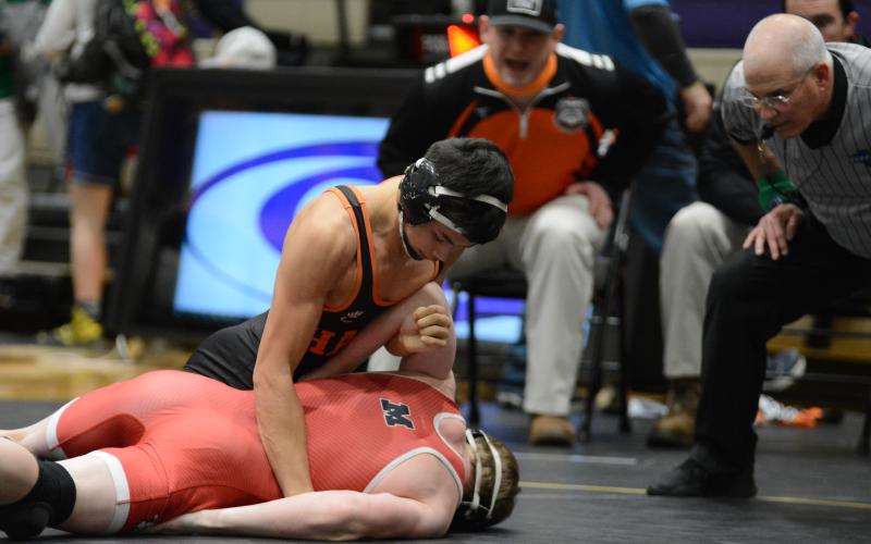Miguel Jaimes holds down a Morgan County wrestler on Jan. 30.