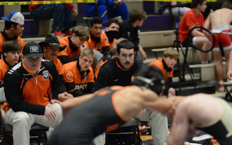 Hart County assistant coach Matthew Patton, left, and head coach Sean Gaddy, right, watch a Hart County wrestler on the mat.
