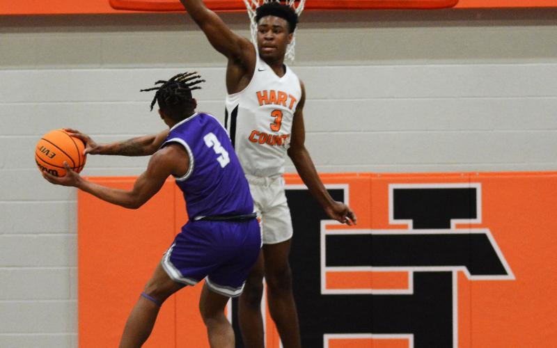 Tahj Johnson prohibits an open shot by a Cherokee Bluff player on Feb. 27, at Hart County High School.