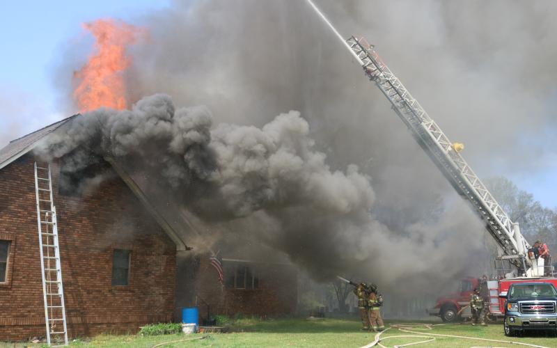 Sunshot by Grayson Williams - A house fire on Goldmine Holly Springs Road destroyed a residence after fire crews battled back flames for more than eight hours on Friday, March 26.